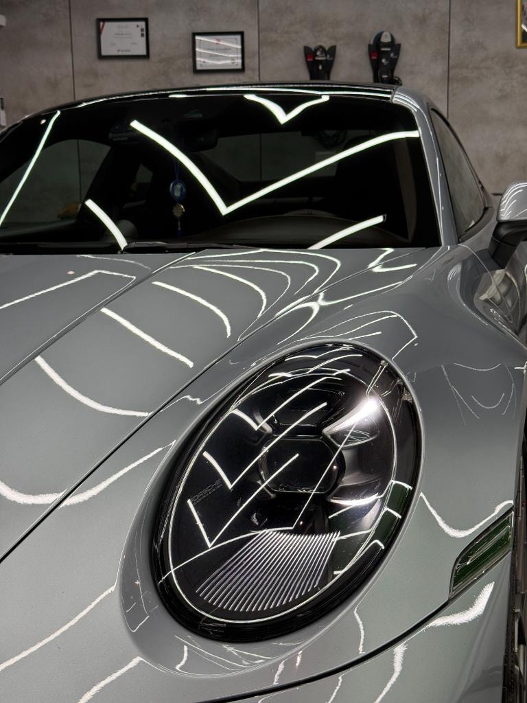 Polished gray sports car in the PROSPERA Auto Spa studio