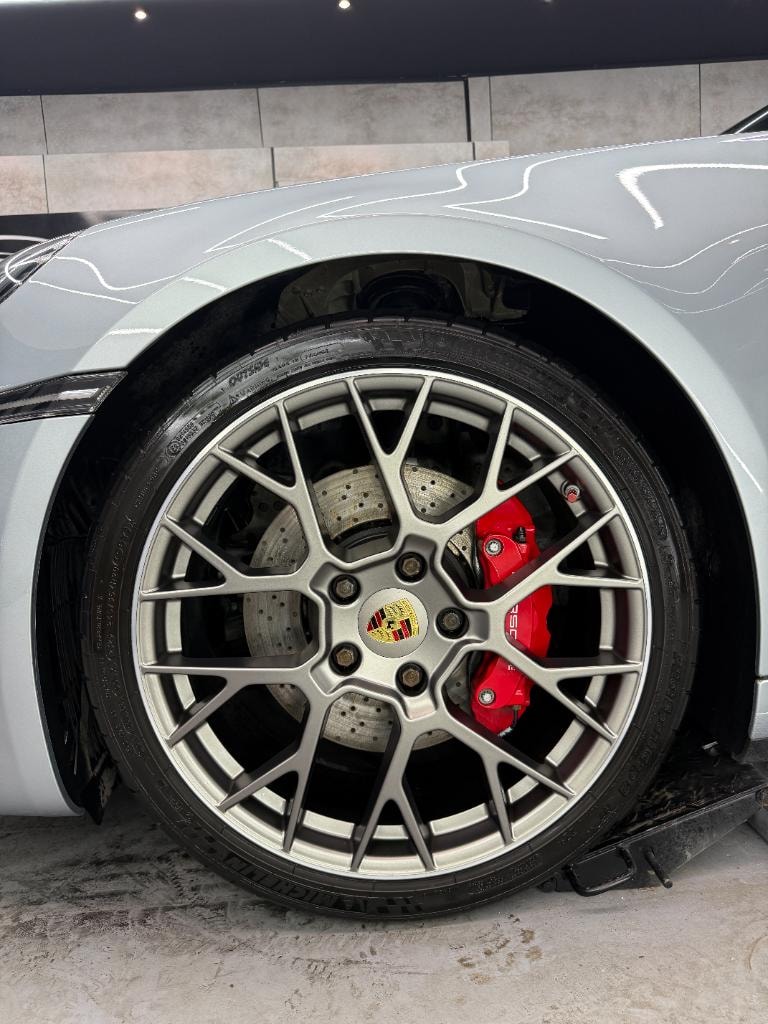Porsche wheel with performance brake caliper at the Auto Spa